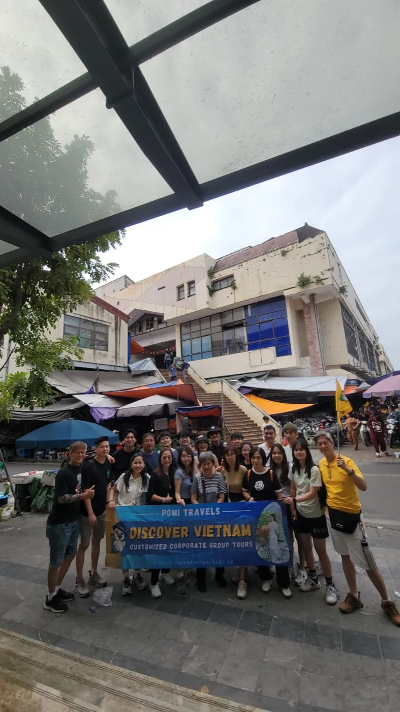 A Pomi Travels group with their Discover Vietnam banner on tour