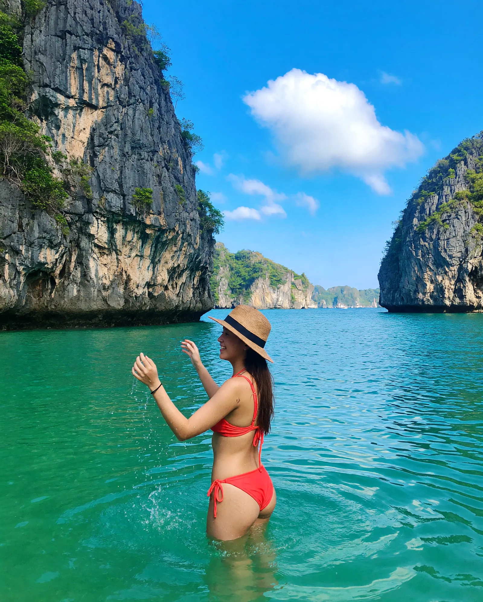 Swimming in the emerald waters of Ha Long Bay near a limestone island